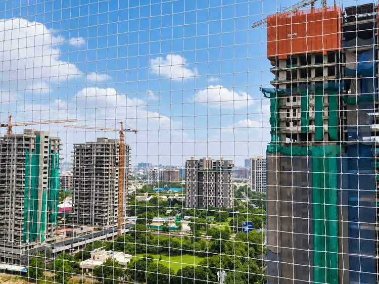 Balcony bird net installation on a high-rise residential building